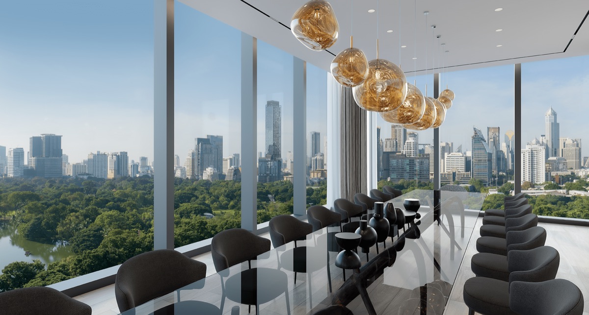 The Social Table — a long dining table beside floor-to-ceiling windows overlooking Lumphini Park